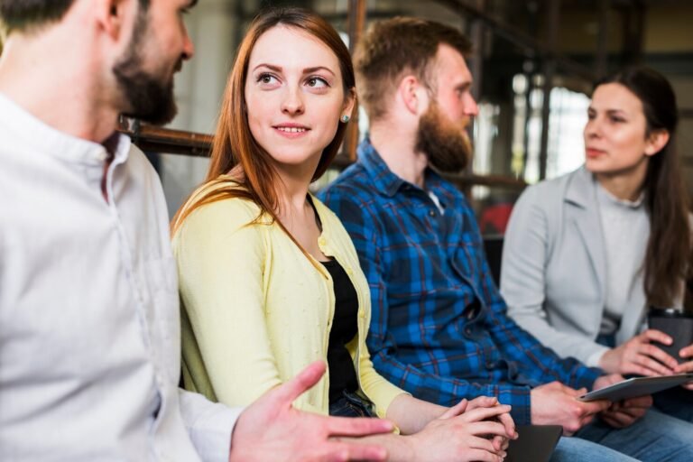 office-colleagues-discussing-with-each-other-workplace_23-2148187221